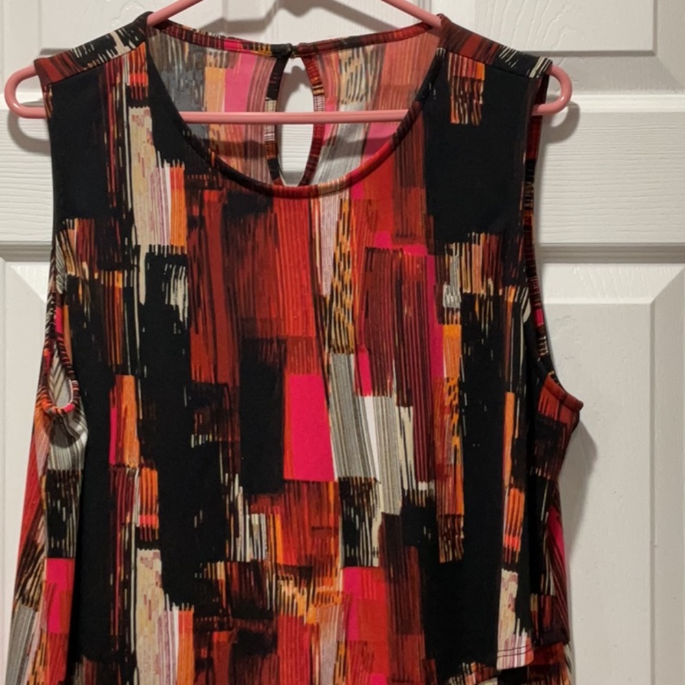 Tunic Top in black, rust, orange, pink & tan asymmetrical ruffle across shirt